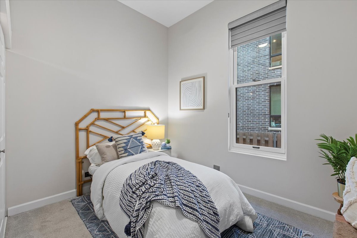 1867 North Halsted Street, Unit 1N Chicago, IL 60614 - Photo 18 of 30 a bed sitting in a bedroom next to a window