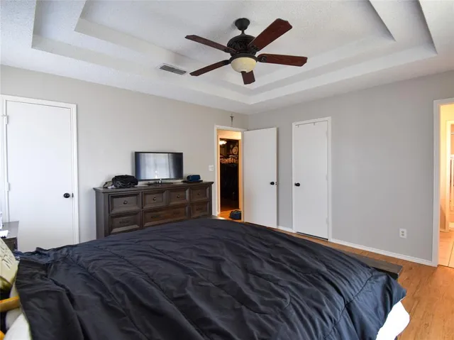 a bedroom with a bed and a chandelier