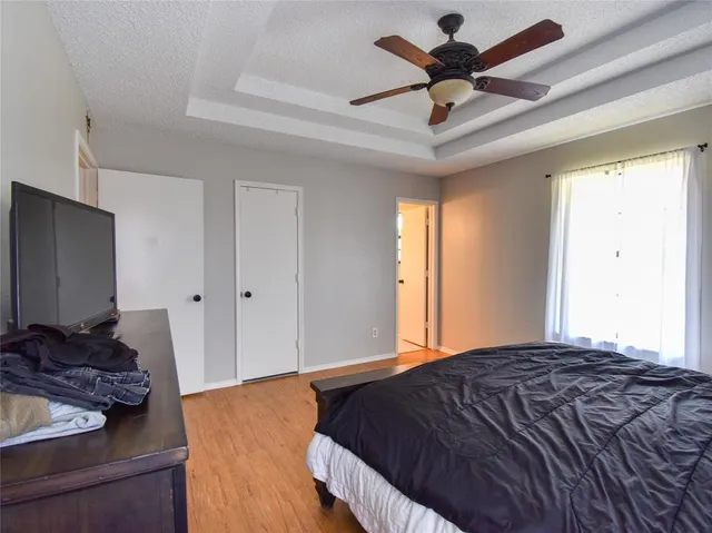a bedroom with a bed and a chandelier