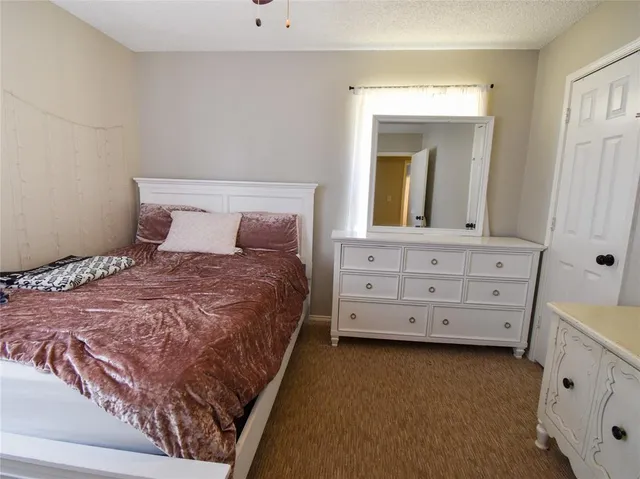 a bedroom with a bed and a dresser