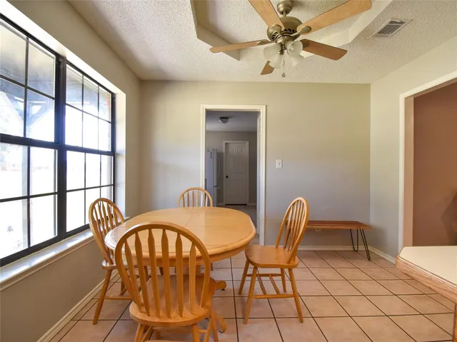 a kitchen with stainless steel appliances granite countertop a refrigerator a stove top oven a sink and dishwasher