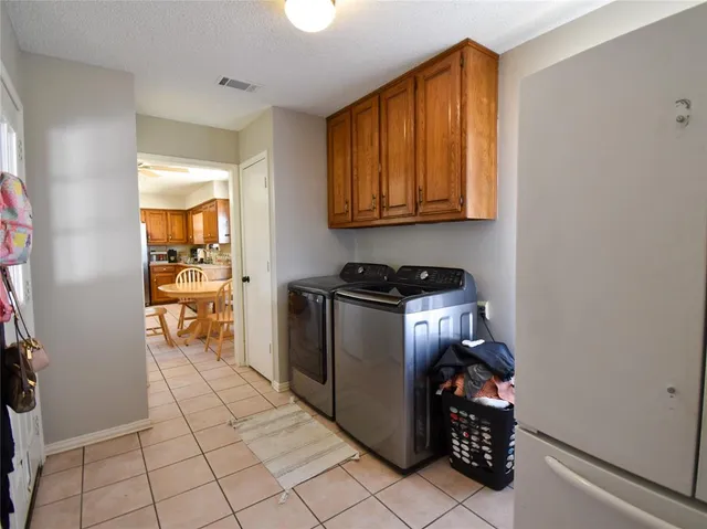 a kitchen with a refrigerator and cabinets