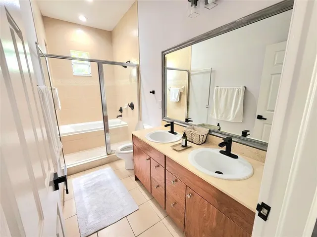 a bathroom with a sink a tub and a mirror