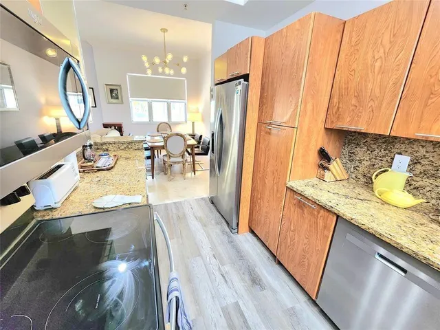 a view of a kitchen area with furniture and wooden floor
