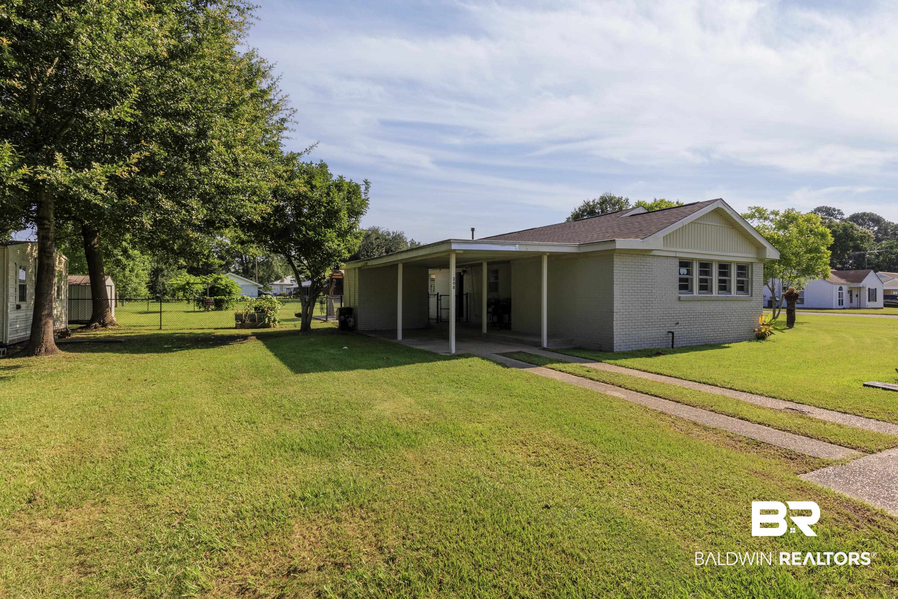 208 Beck Street Atmore, AL 36502 - Photo 9 of 26 Back of house with brick siding and a patio