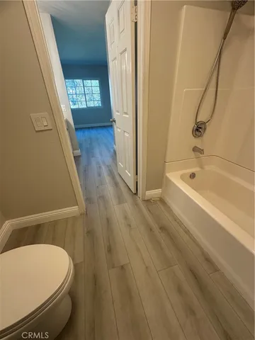 a view of wooden floor and windows in a room