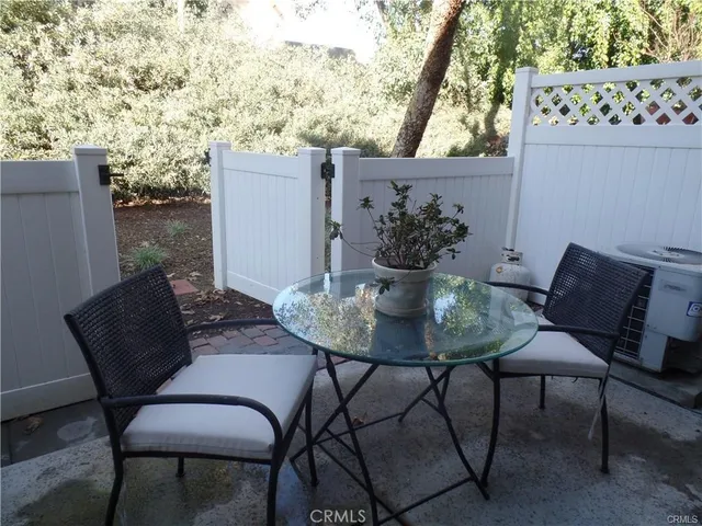 a view of a patio with table and chairs and potted plants