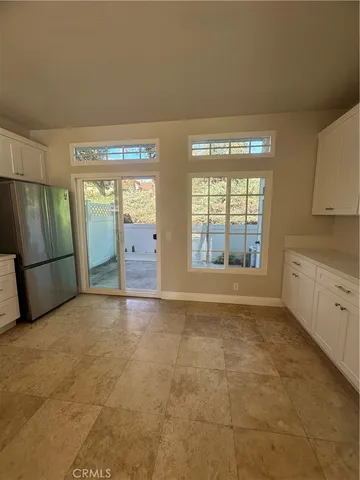 a view of an empty room with a fireplace and a window