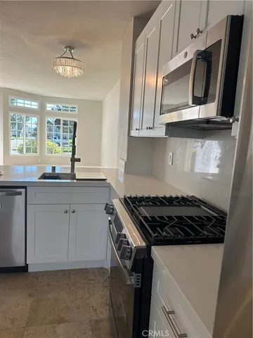 a stove top oven sitting inside of a kitchen