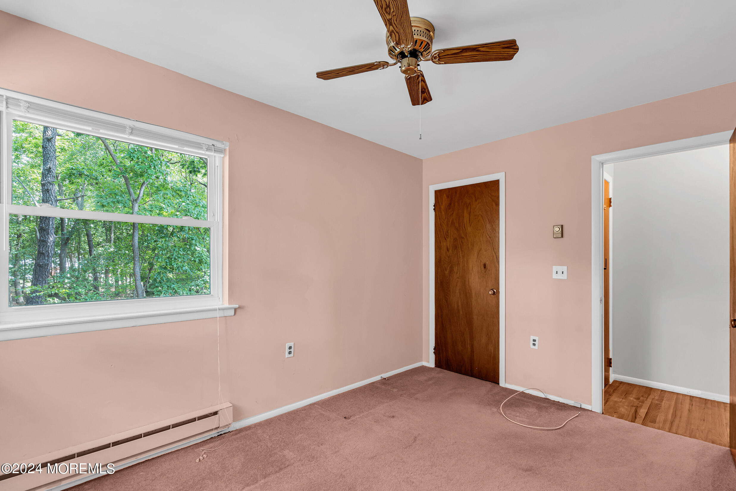 141 B Azalea Drive Whiting, NJ 08759 - Photo 12 of 17 an empty room with ceiling fan and window