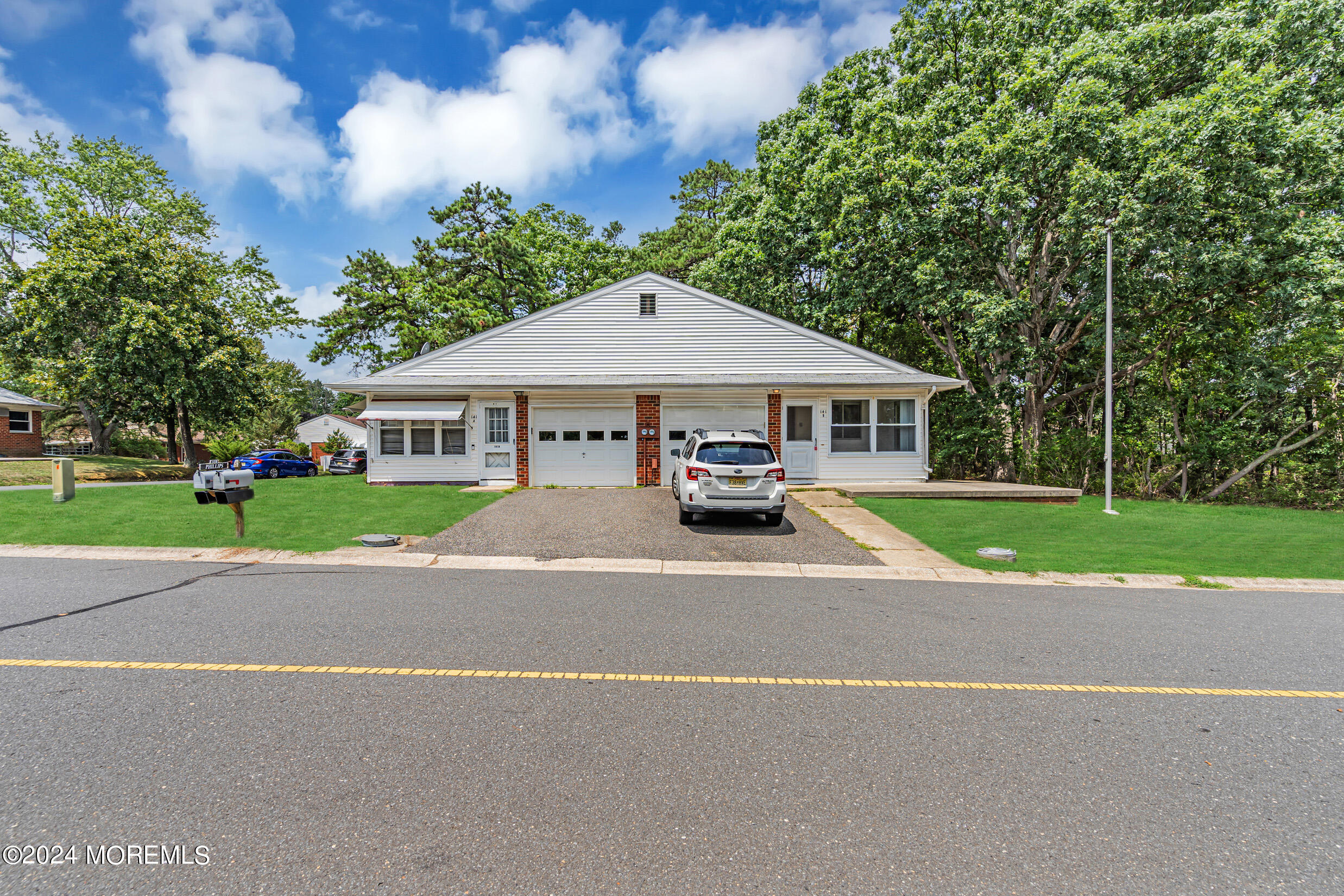 141 B Azalea Drive Whiting, NJ 08759 - Photo 4 of 17 a car parked in front of house with yard outdoor seating and trees in the background