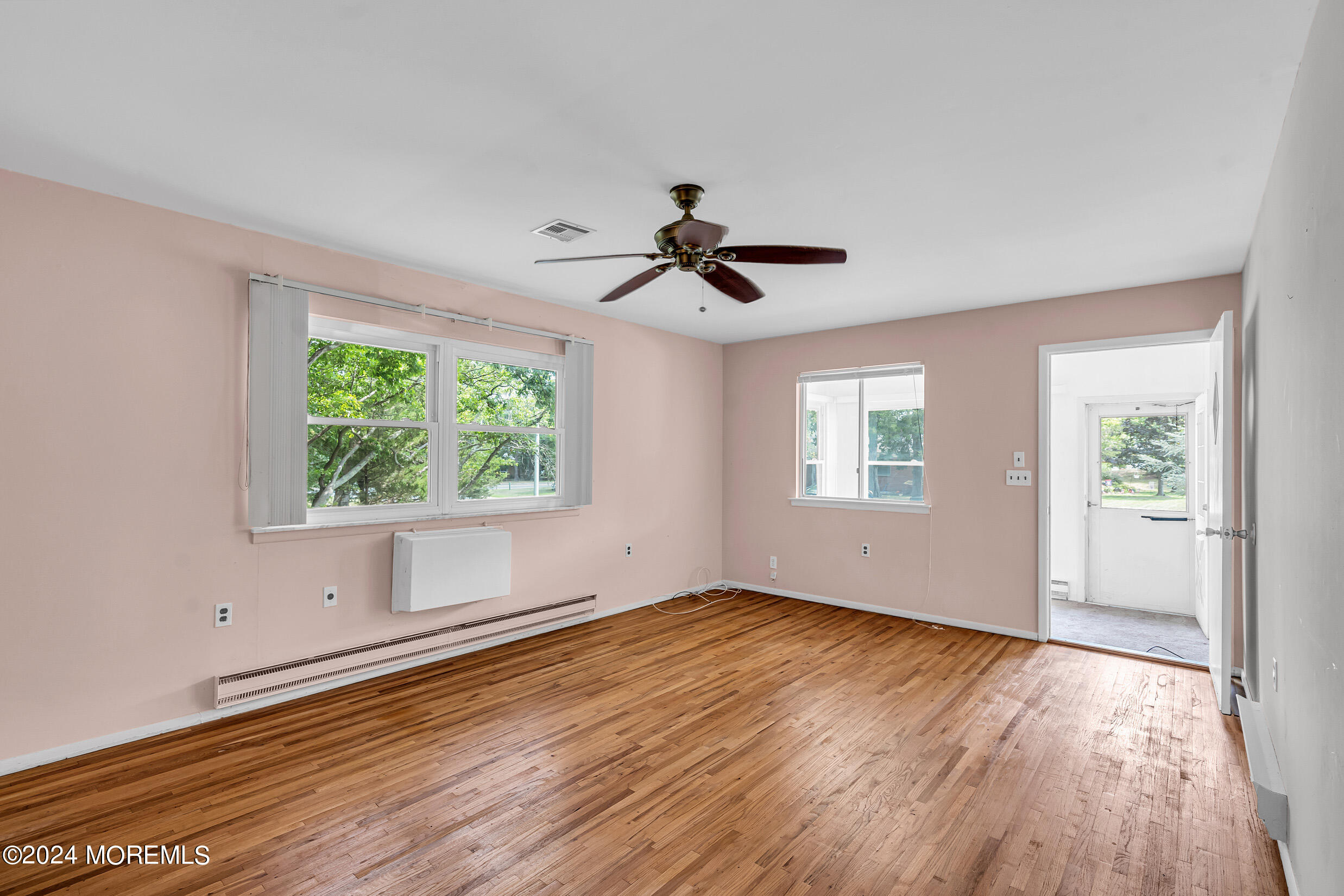 141 B Azalea Drive Whiting, NJ 08759 - Photo 5 of 17 a view of an empty room with wooden floor and a window