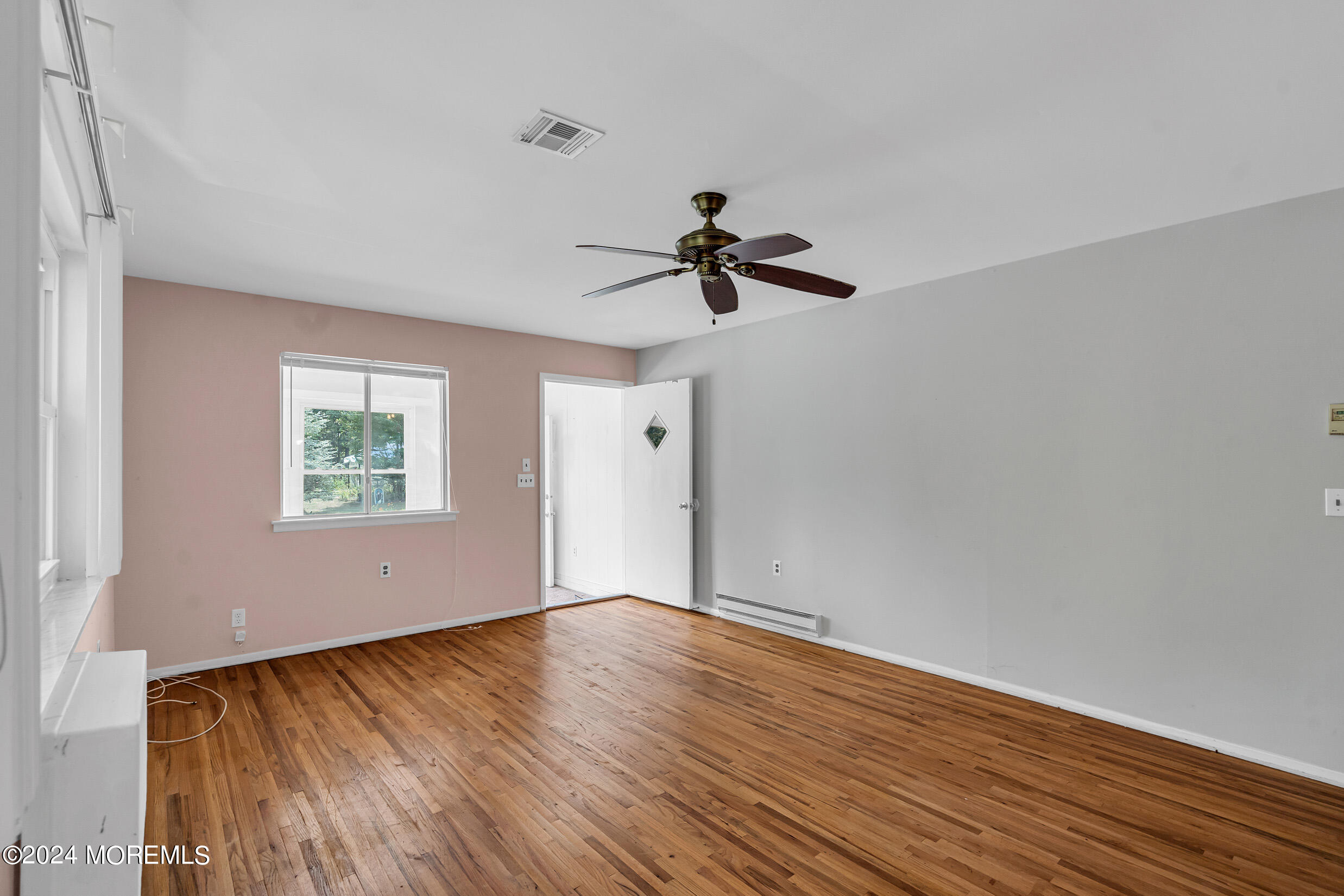 141 B Azalea Drive Whiting, NJ 08759 - Photo 6 of 17 a view of empty room with wooden floor and fan
