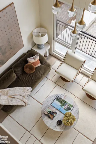 a living room with furniture a rug and white walls