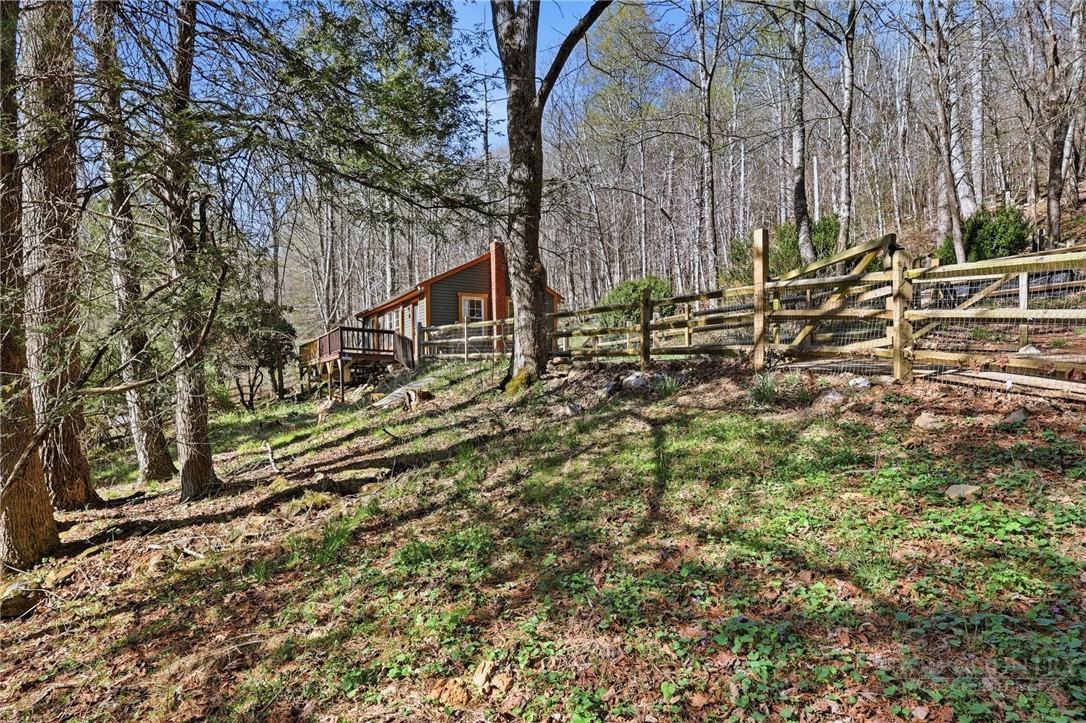 286 Grady Winkler Road Boone, NC 28607 - Photo 12 of 13 a view of a wooden house with a yard