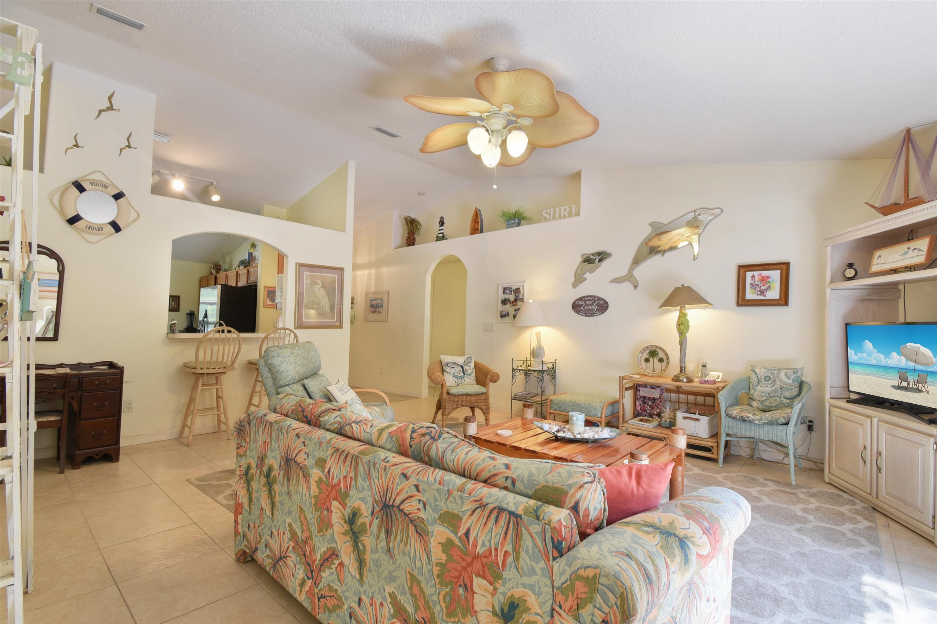 1711 Old Beach Road St. Augustine, FL 32080 - Photo 11 of 34 a living room with furniture and a chandelier