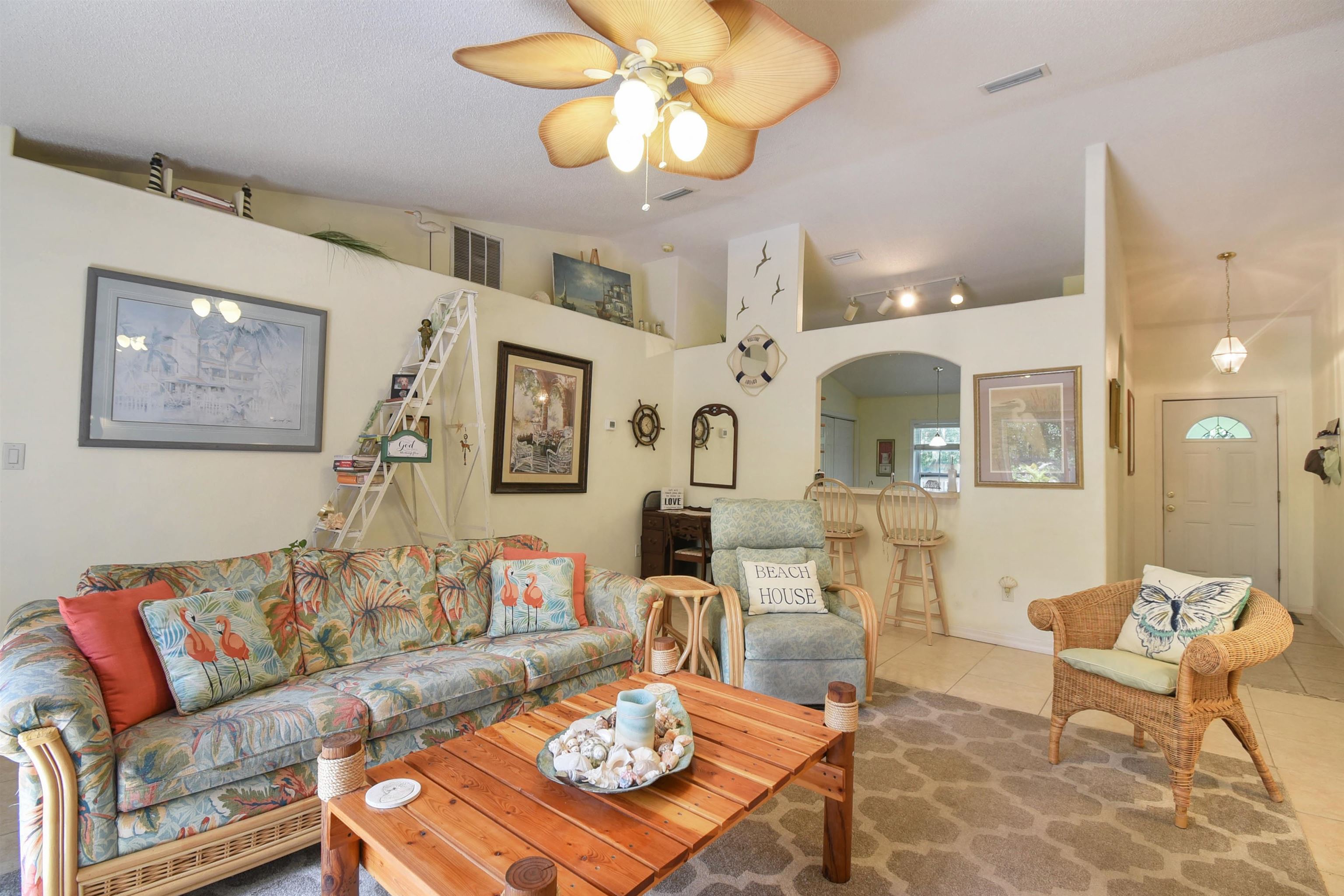 1711 Old Beach Road St. Augustine, FL 32080 - Photo 12 of 34 a living room with fireplace furniture and a chandelier