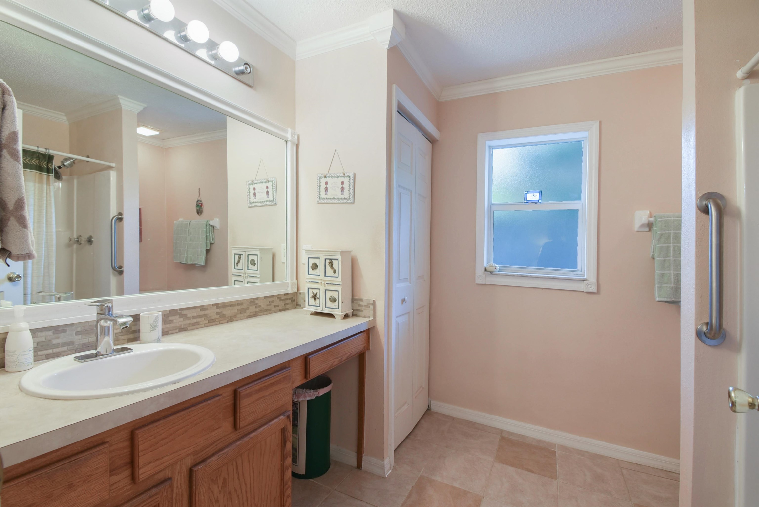1711 Old Beach Road St. Augustine, FL 32080 - Photo 16 of 34 a bathroom with a sink double vanity and a mirror