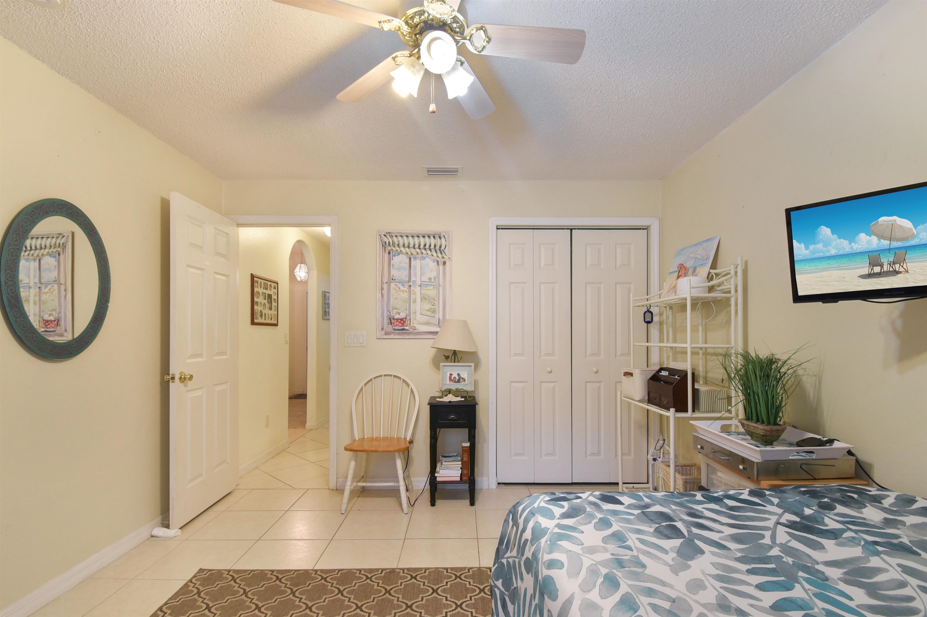 1711 Old Beach Road St. Augustine, FL 32080 - Photo 19 of 34 a bedroom with a bed and a chandelier