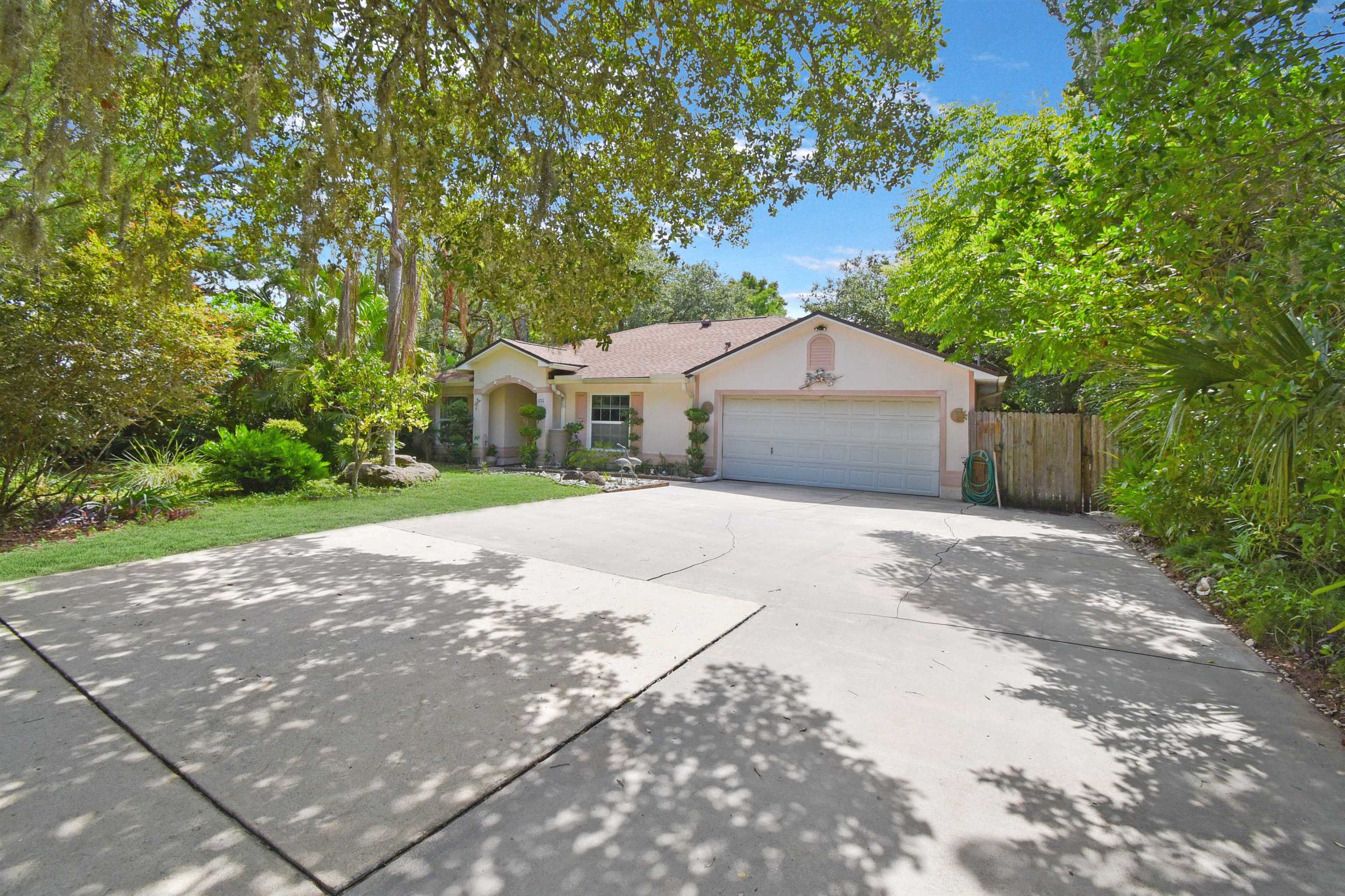 1711 Old Beach Road St. Augustine, FL 32080 - Photo 2 of 34 a front view of a house with a yard and garage