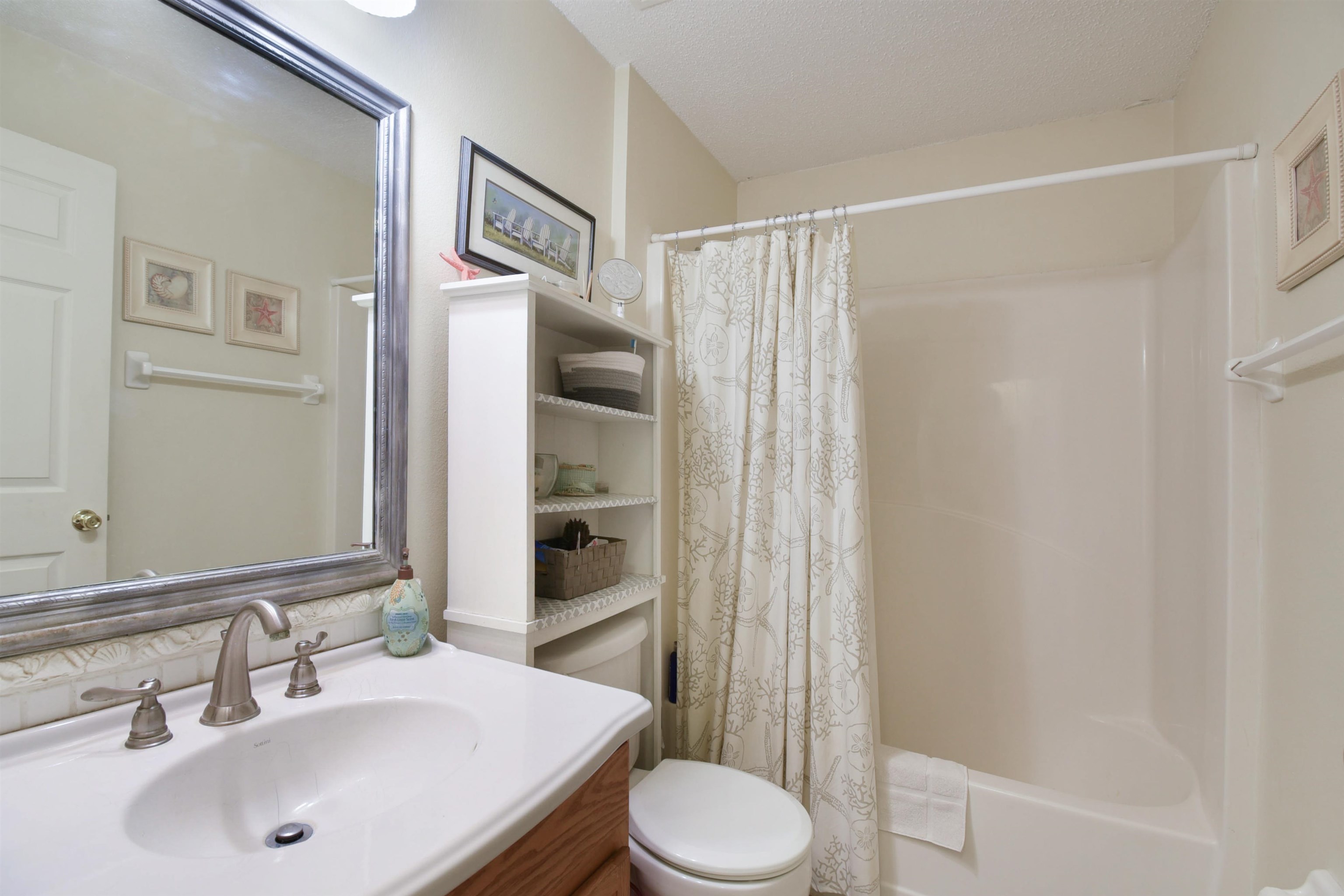1711 Old Beach Road St. Augustine, FL 32080 - Photo 21 of 34 a bathroom with a sink toilet and shower