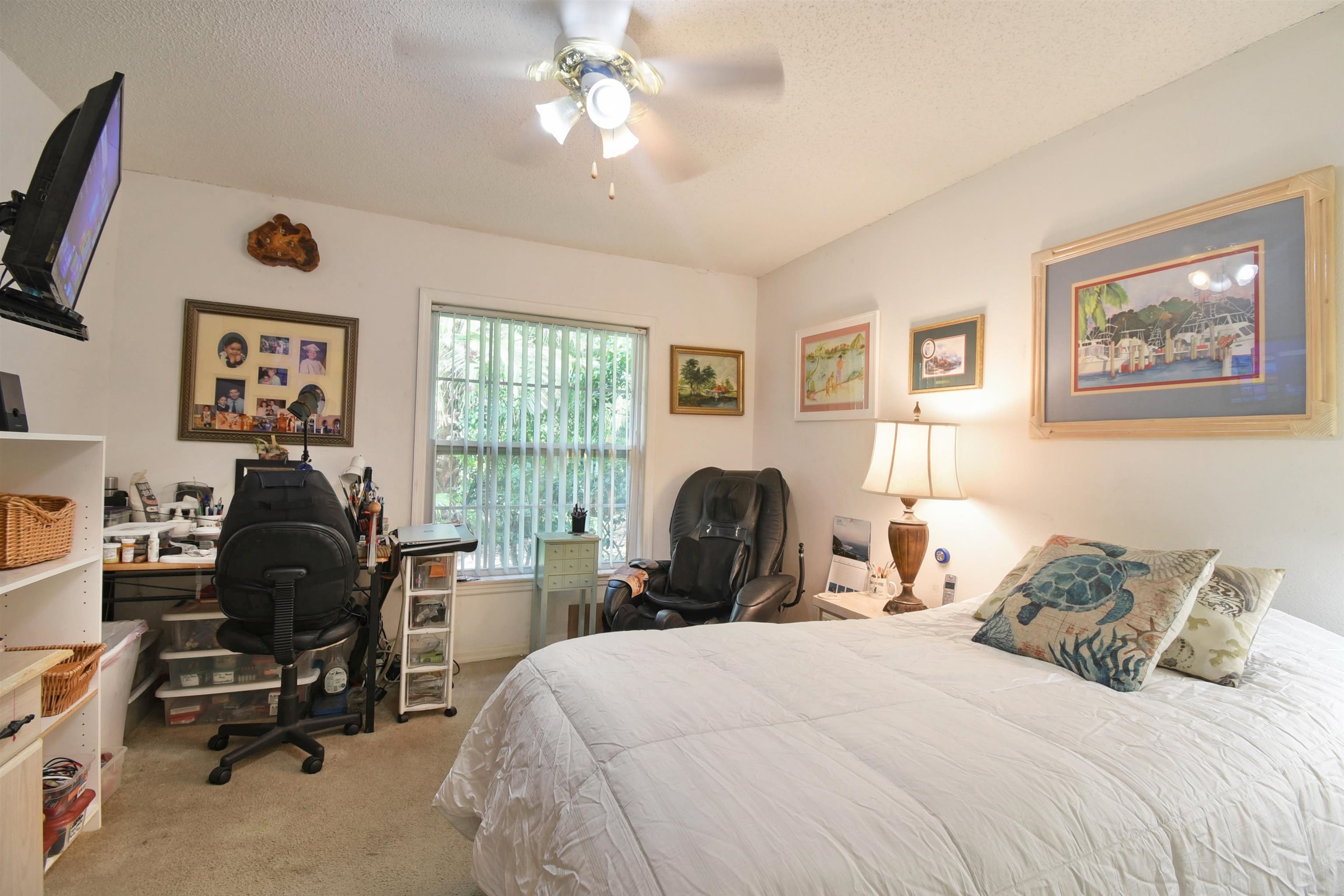 1711 Old Beach Road St. Augustine, FL 32080 - Photo 22 of 34 a bedroom with a bed and a chandelier