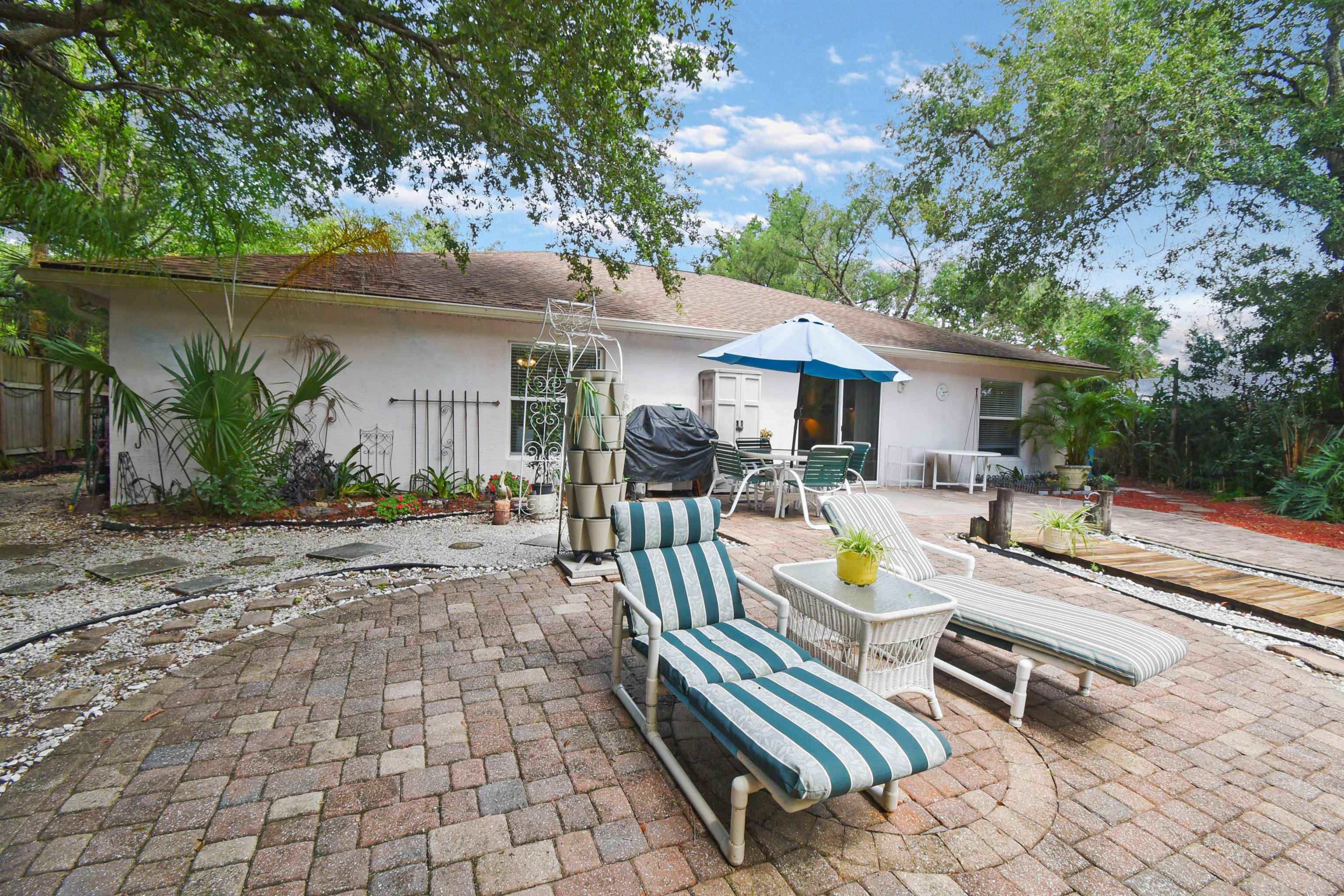 1711 Old Beach Road St. Augustine, FL 32080 - Photo 24 of 34 a view of a patio with chairs and potted plants