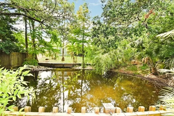 an aerial view of a house with outdoor space and trees all around