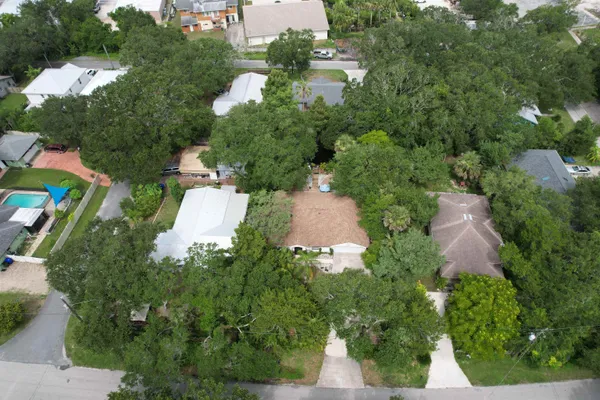 an aerial view of city with green space