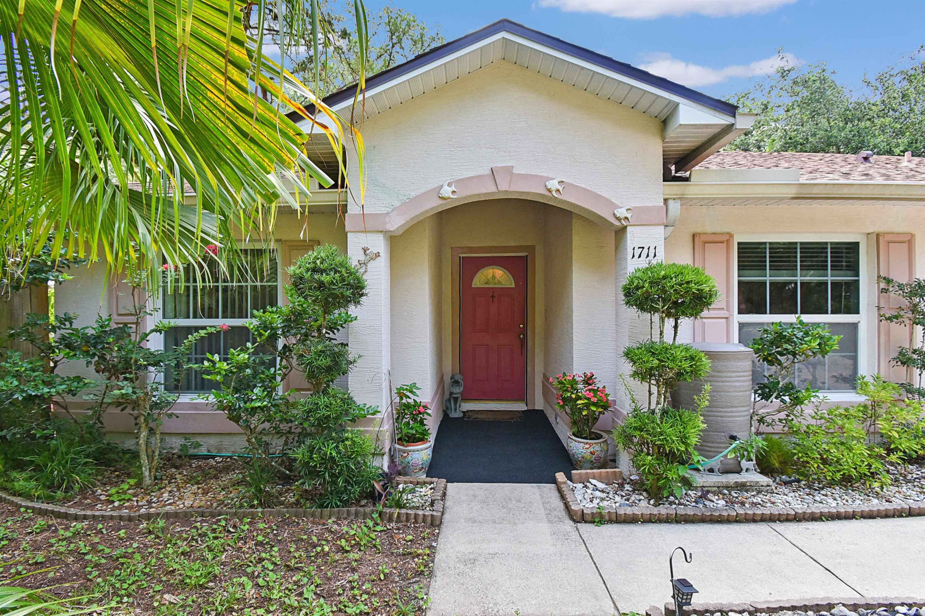 1711 Old Beach Road St. Augustine, FL 32080 - Photo 4 of 34 a front view of a house with garden
