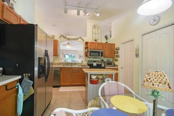 a kitchen with stainless steel appliances granite countertop a sink a stove and cabinets