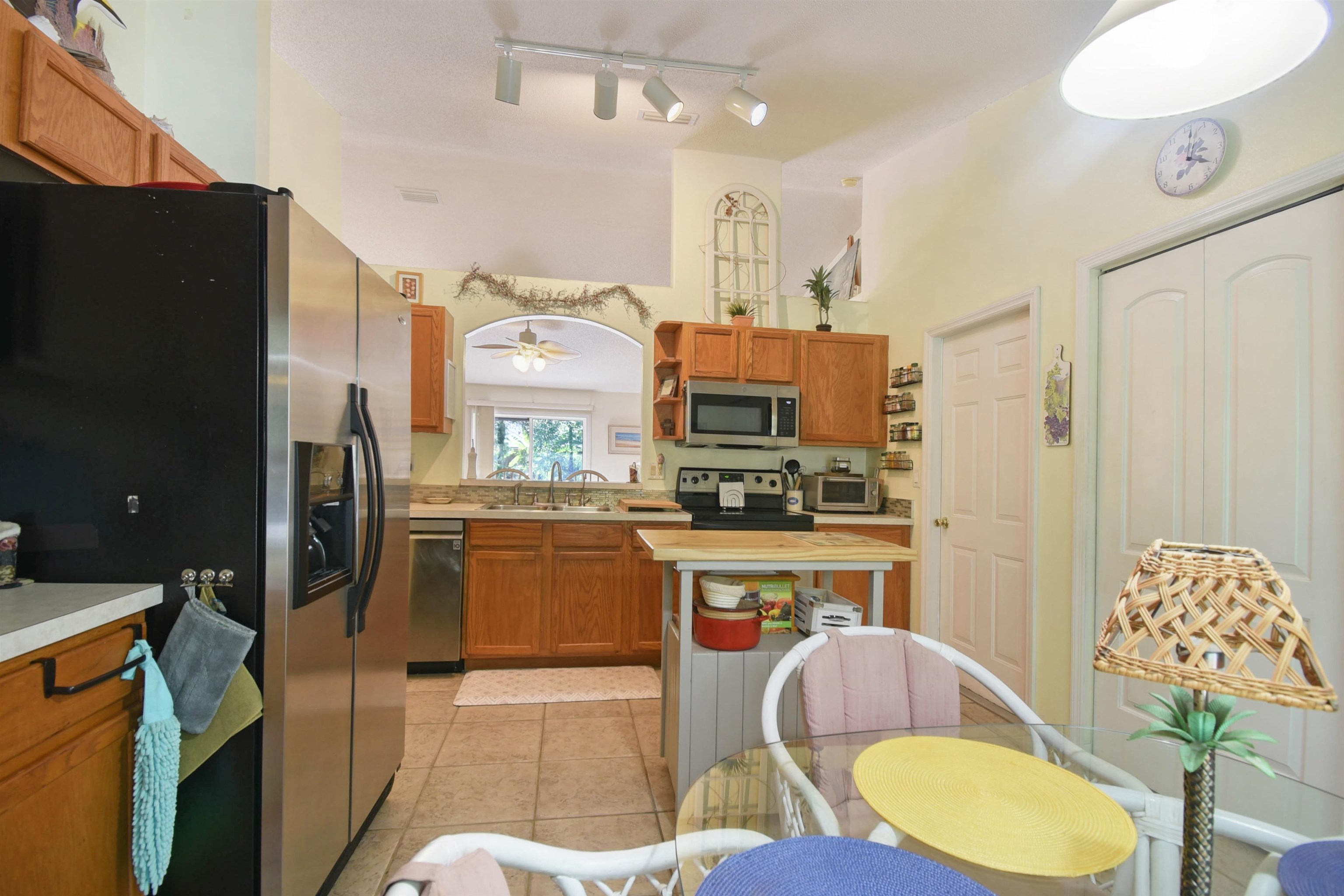 1711 Old Beach Road St. Augustine, FL 32080 - Photo 7 of 34 a kitchen with stainless steel appliances kitchen island granite countertop a refrigerator a stove top oven and a sink