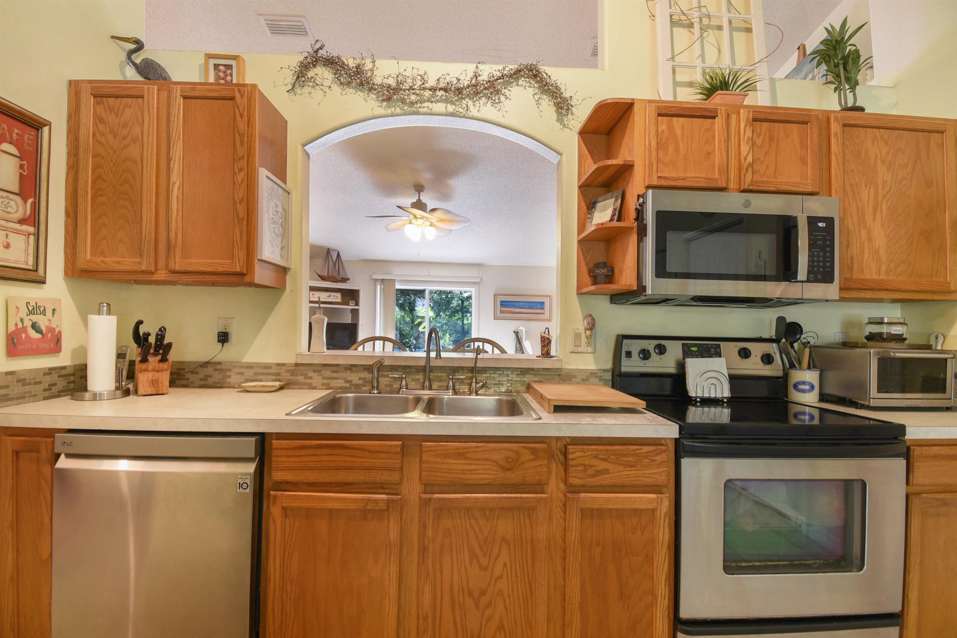 1711 Old Beach Road St. Augustine, FL 32080 - Photo 8 of 34 a kitchen with stainless steel appliances granite countertop a sink a stove and cabinets