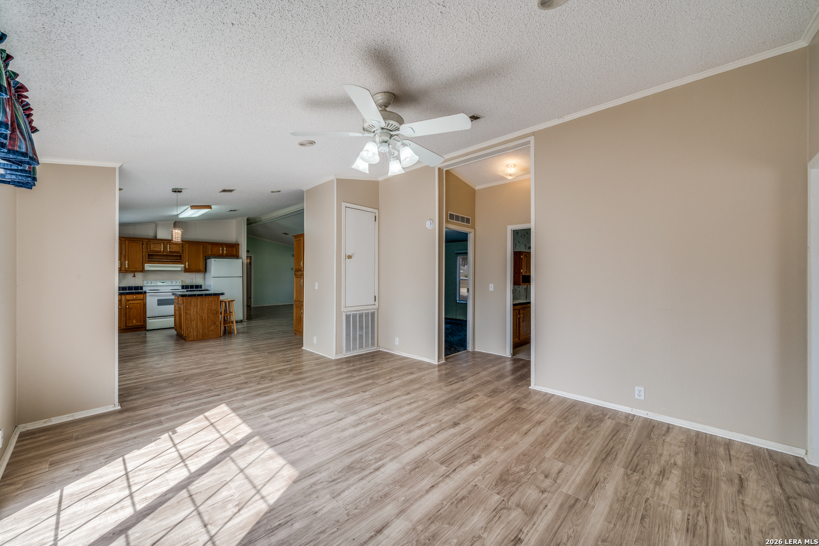 14975 Flatten Road San Antonio, TX 78223 - Photo 12 of 28 a living room with furniture and a chandelier