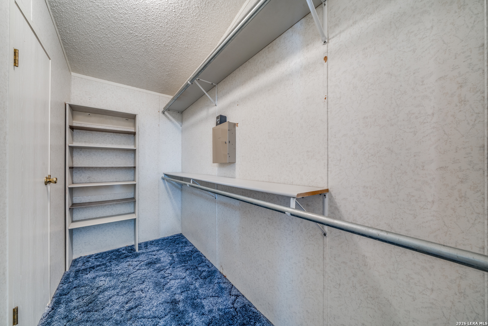 14975 Flatten Road San Antonio, TX 78223 - Photo 18 of 28 a view of walk in closet with empty racks