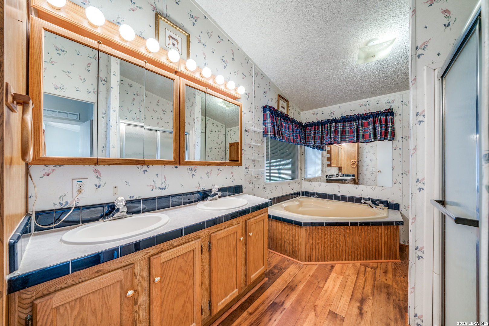 14975 Flatten Road San Antonio, TX 78223 - Photo 19 of 28 a bathroom with a sink and a mirror