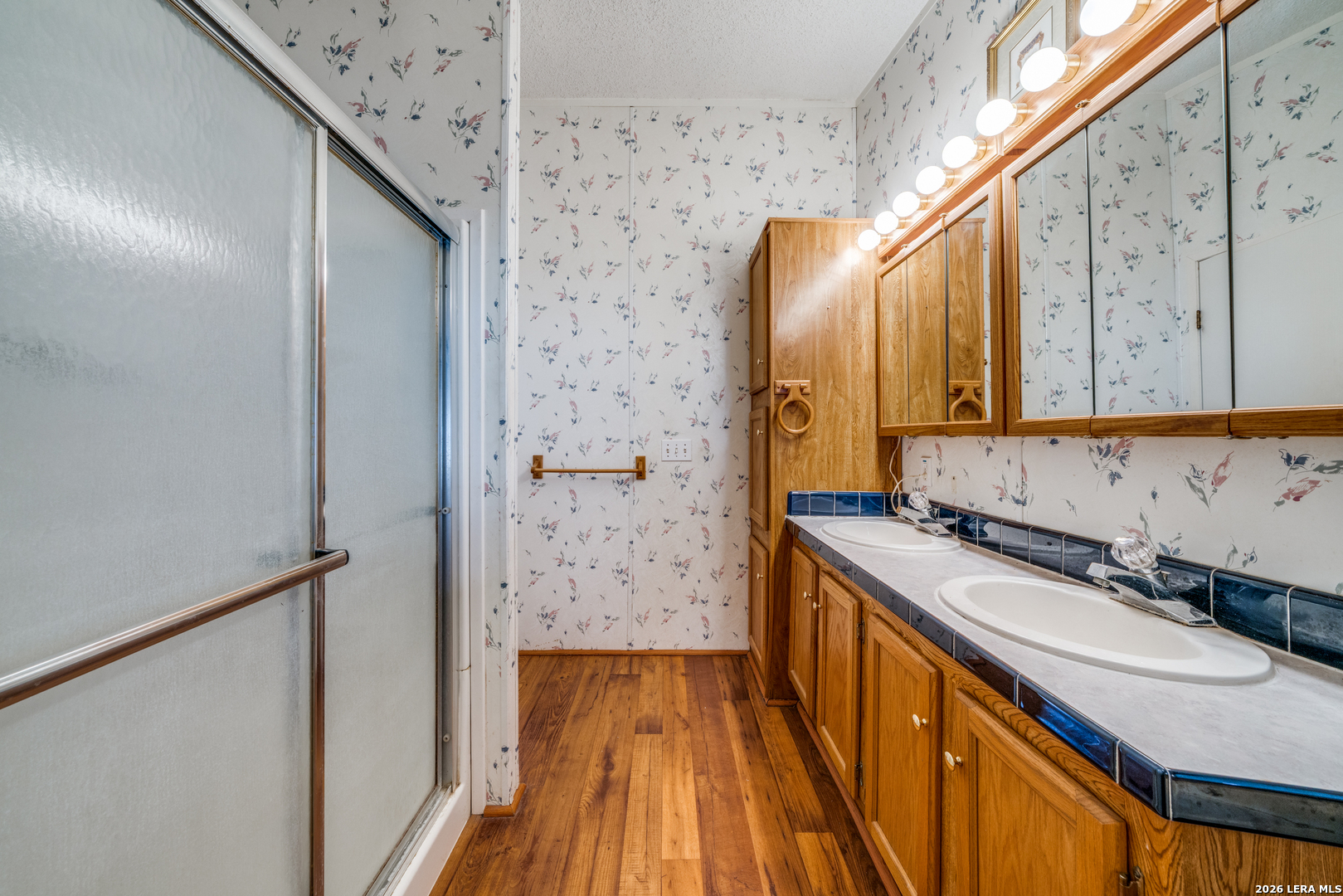 14975 Flatten Road San Antonio, TX 78223 - Photo 20 of 28 a bathroom with a sink and a mirror