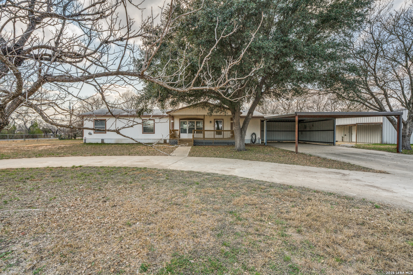 14975 Flatten Road San Antonio, TX 78223 - Photo 2 of 28 a front view of a house with a yard