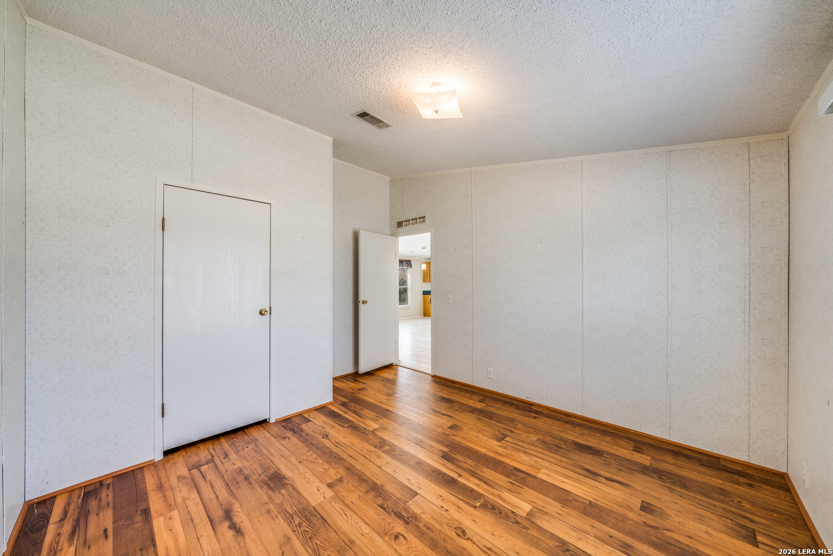14975 Flatten Road San Antonio, TX 78223 - Photo 21 of 28 a view of room with wooden floor