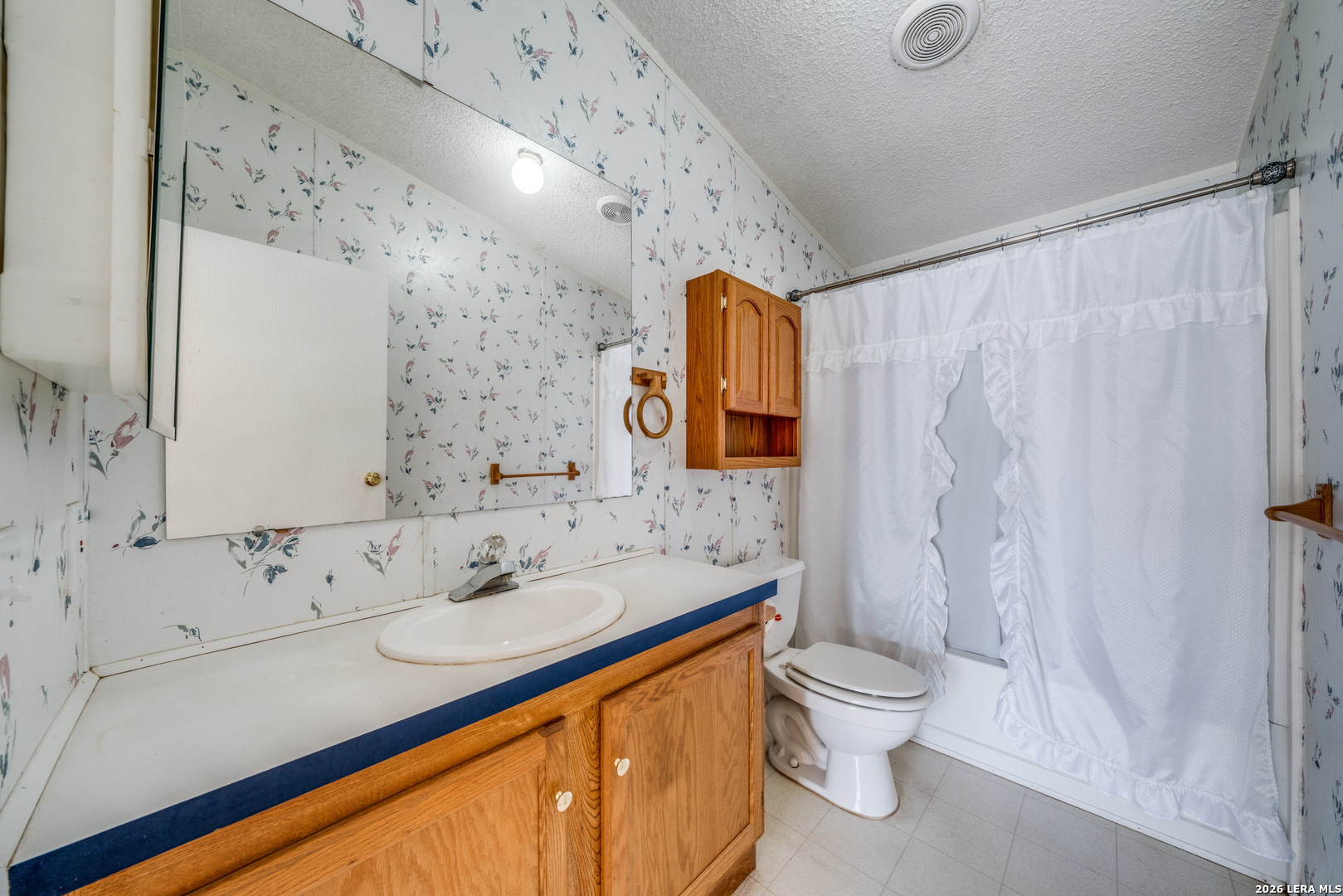 14975 Flatten Road San Antonio, TX 78223 - Photo 22 of 28 a bathroom with a sink toilet and shower