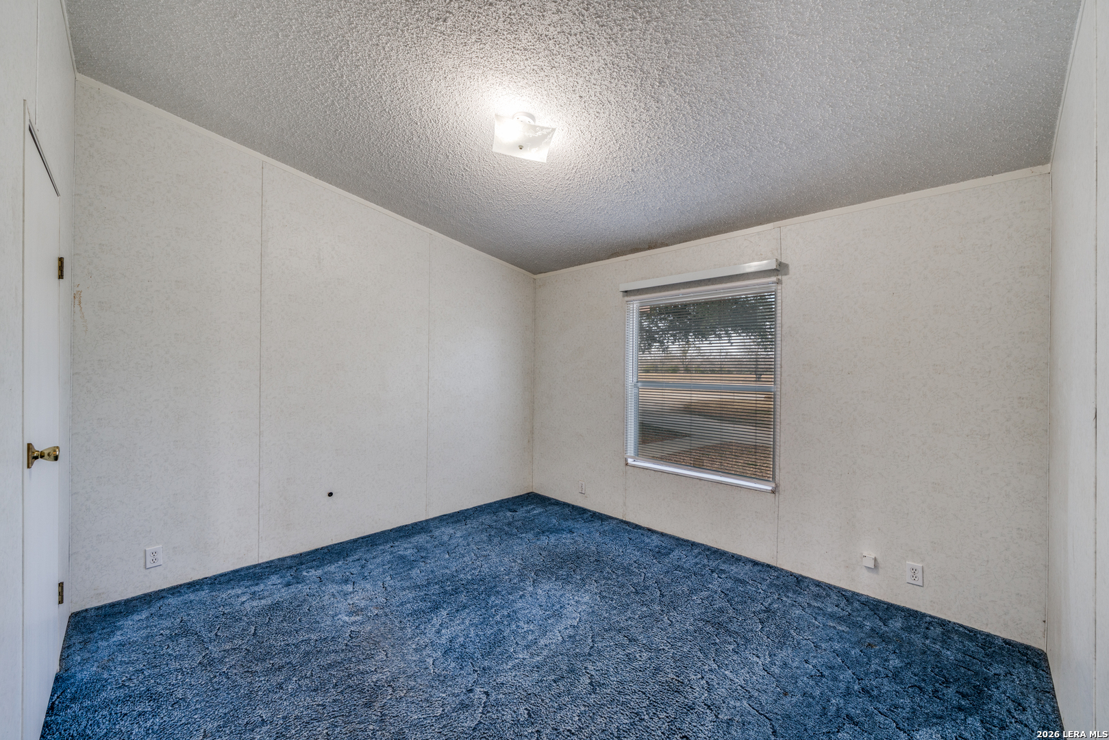 14975 Flatten Road San Antonio, TX 78223 - Photo 23 of 28 an empty room with a window