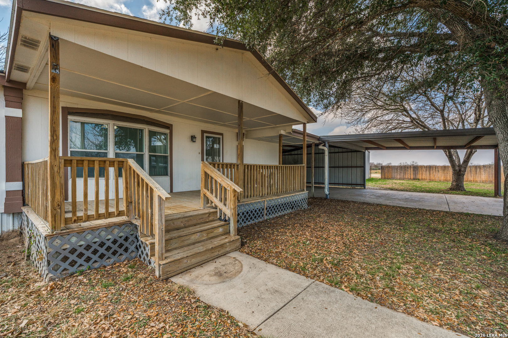 14975 Flatten Road San Antonio, TX 78223 - Photo 4 of 28 a view of a house with a large window and wooden fence