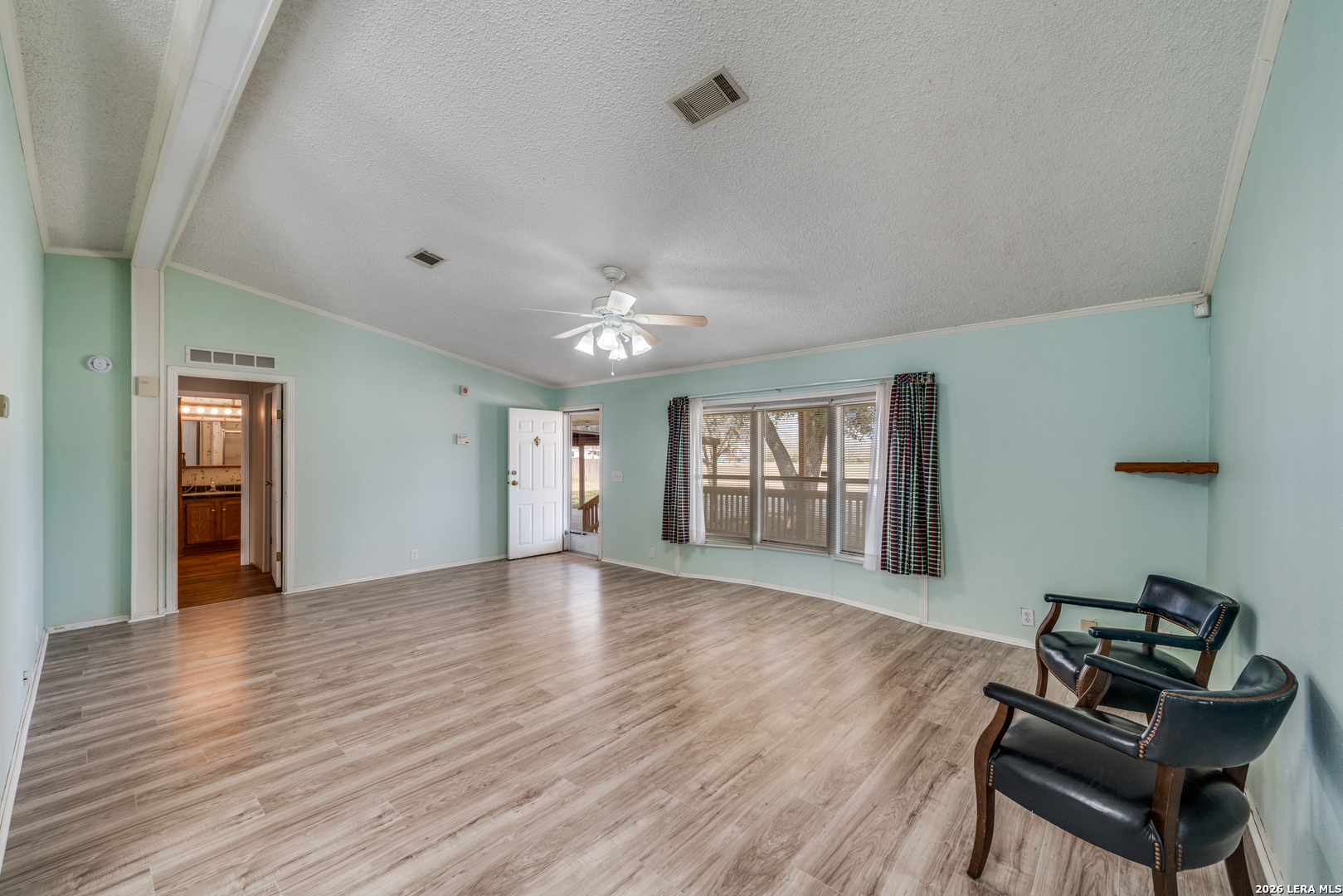 14975 Flatten Road San Antonio, TX 78223 - Photo 7 of 28 a view of an empty room with wooden floor and a window