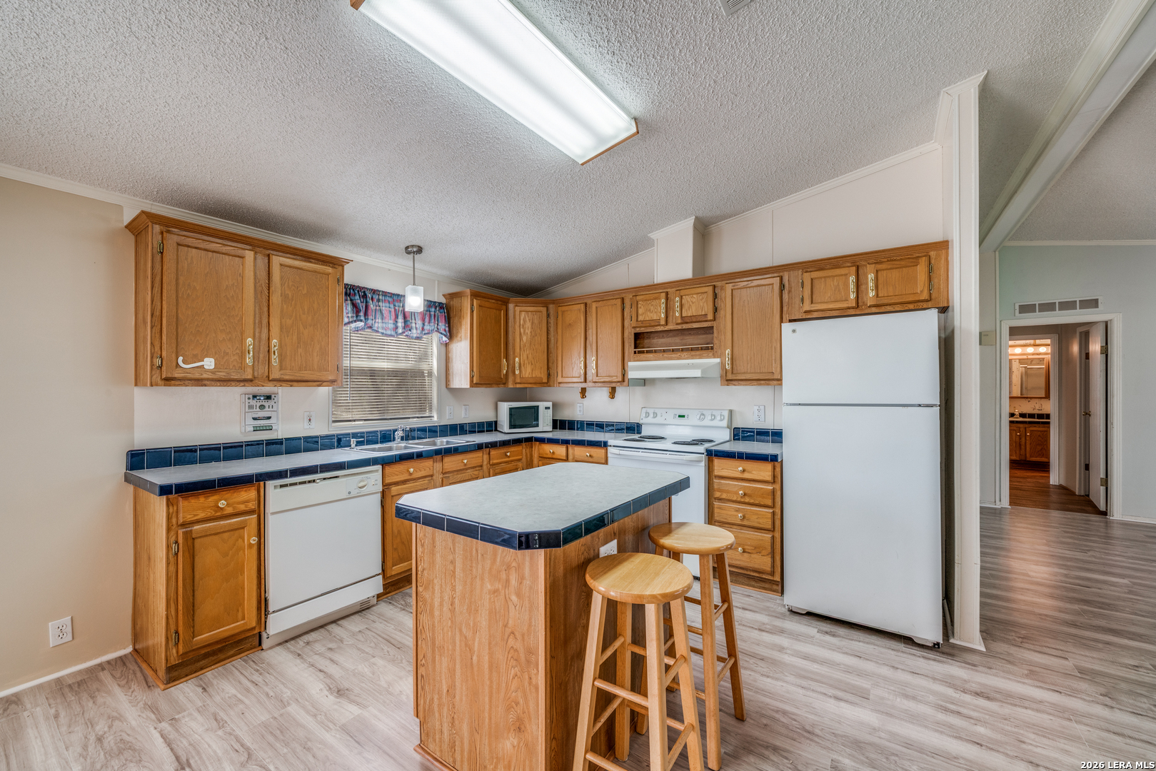 14975 Flatten Road San Antonio, TX 78223 - Photo 9 of 28 a kitchen with stainless steel appliances granite countertop refrigerator stove top oven and sink