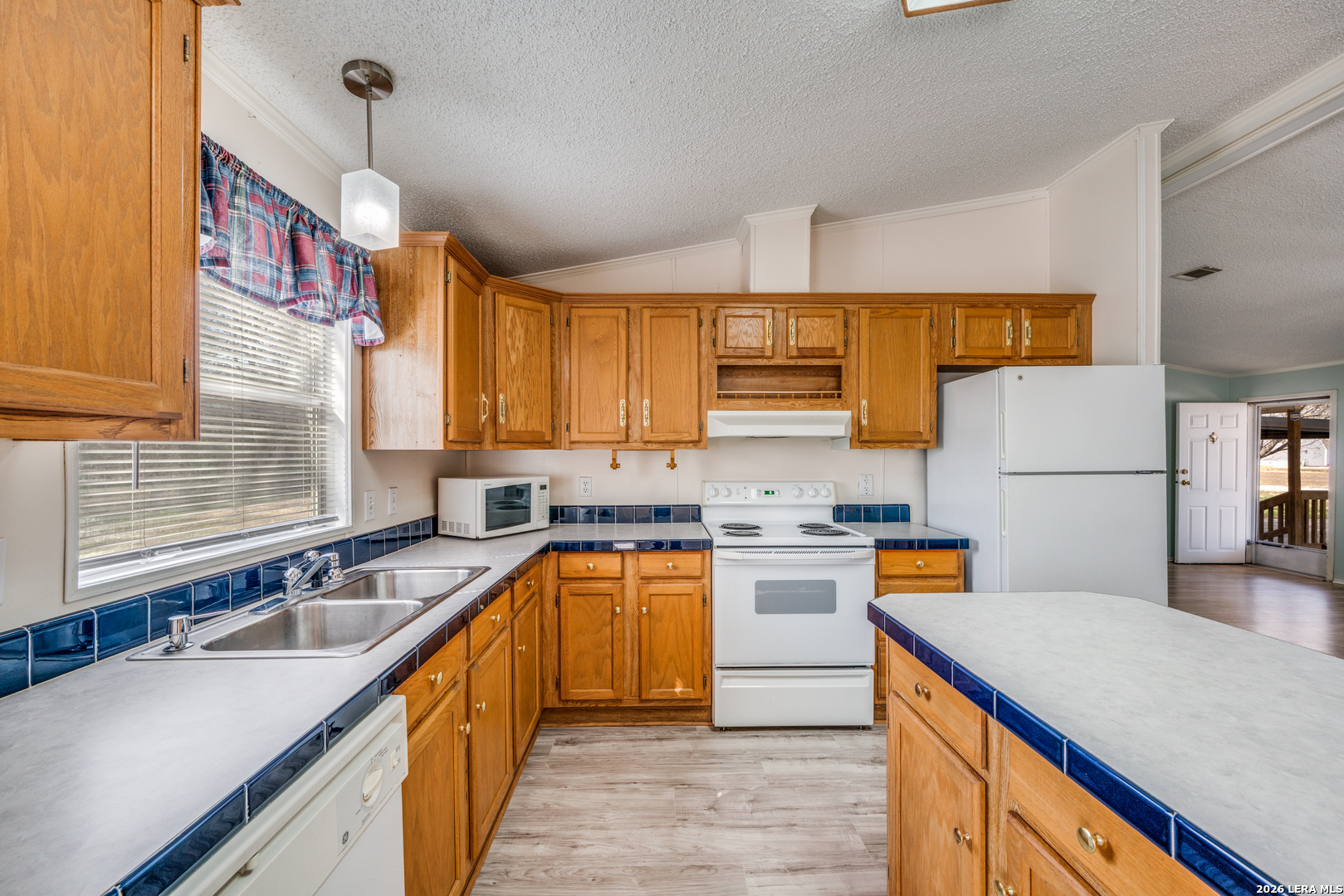 14975 Flatten Road San Antonio, TX 78223 - Photo 10 of 28 a kitchen with stainless steel appliances a sink stove and refrigerator