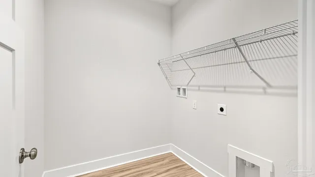 a kitchen with kitchen island white cabinets and wooden floor