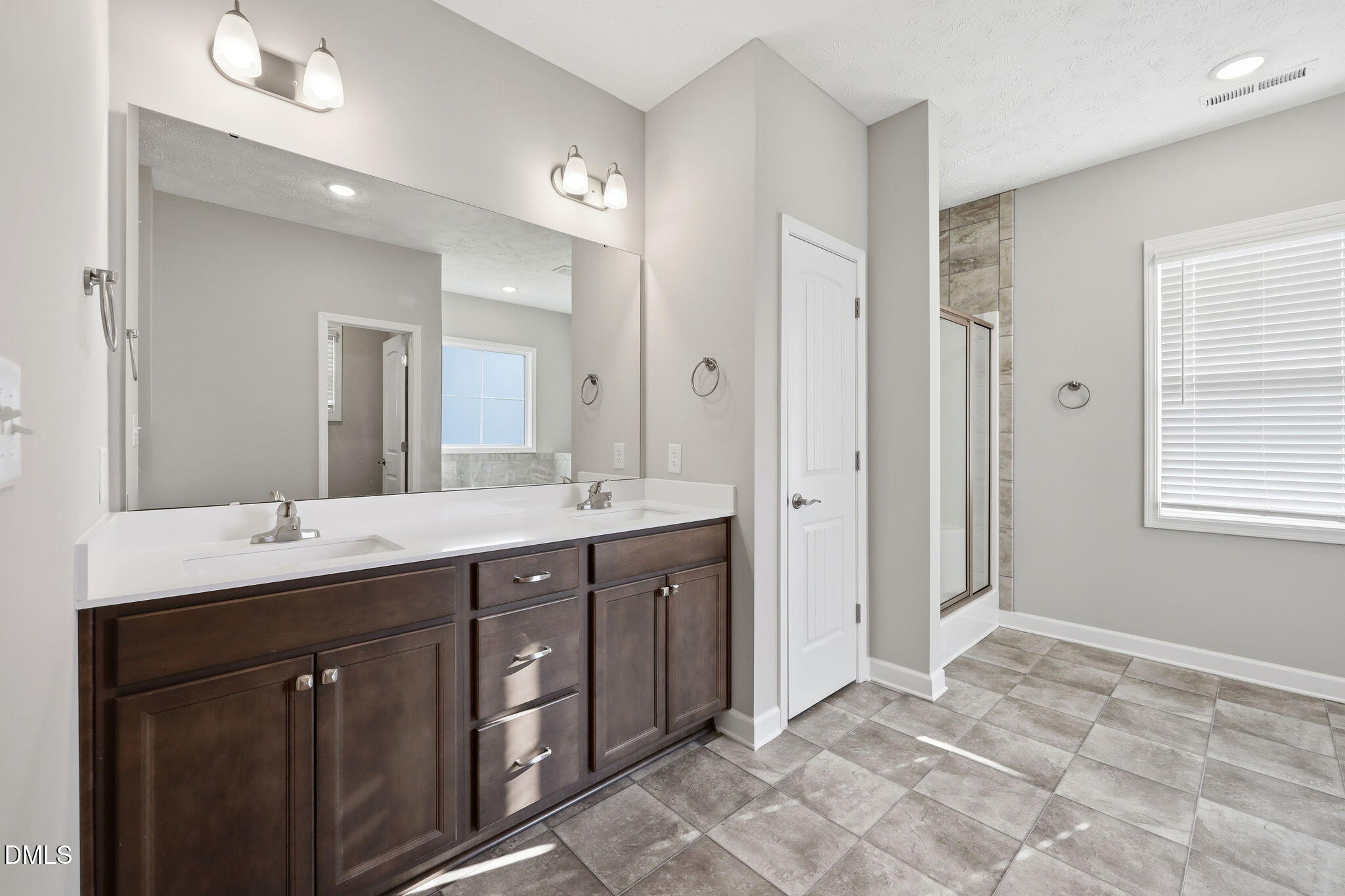 3017 Branscombe Road Fayetteville, NC 28304 - Photo 14 of 43 a spacious bathroom with a double vanity sink a mirror and a