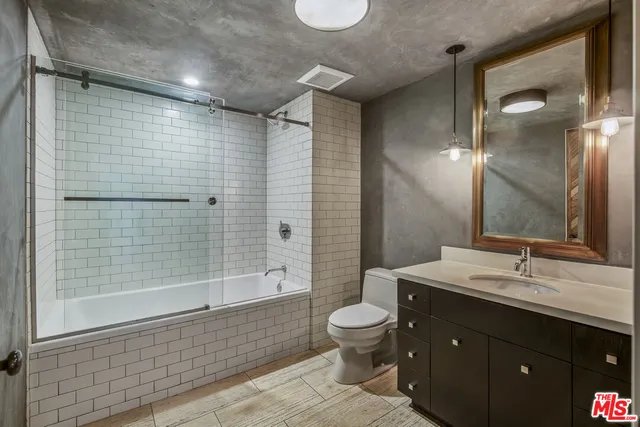a bathroom with a double vanity sink toilet and shower