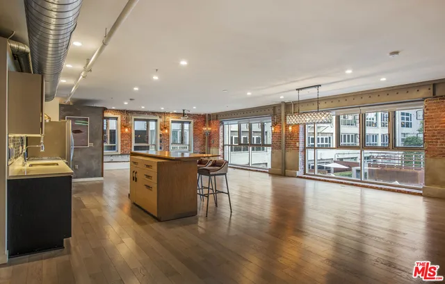 a room with lots of wooden furniture and large windows