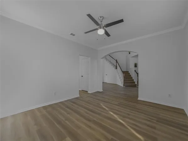 a view of a livingroom with wooden floor and white walls